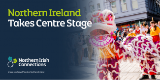 Text says Northern Ireland Takes Centre Stage. Image is of a man dressed as a  dragon in a parade