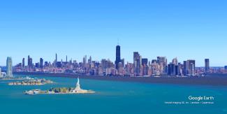Aerial view of New York City skyline with the Statue of Liberty in the foreground across the harbor.