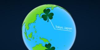 Illustrated globe focused on East Asia and the Pacific Ocean, with a green shamrock marker highlighting Tokyo, Japan.