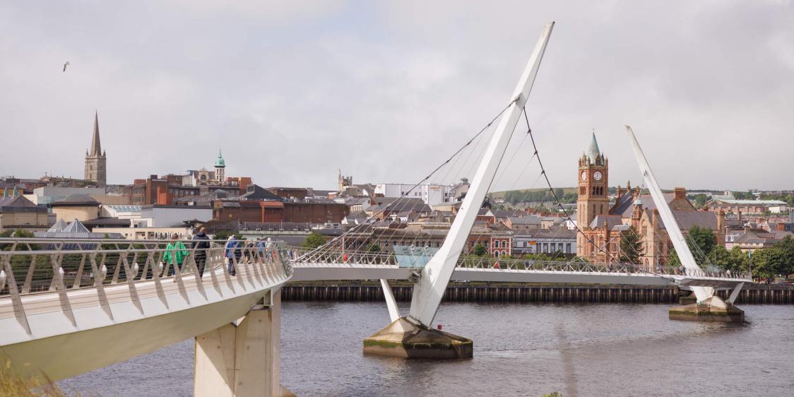 View of the Peace Bridge with Derry skyline backdrop.