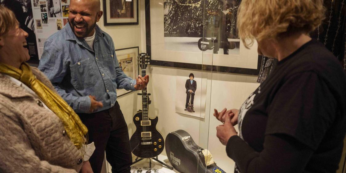 Man playing air guitar while touring the Oh Yeah Music Centre Belfast 