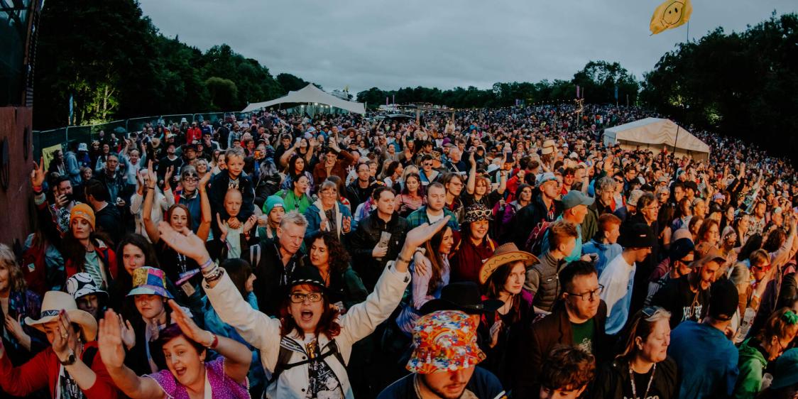 Northern Ireland music festival with large crowd at an outdoor venue