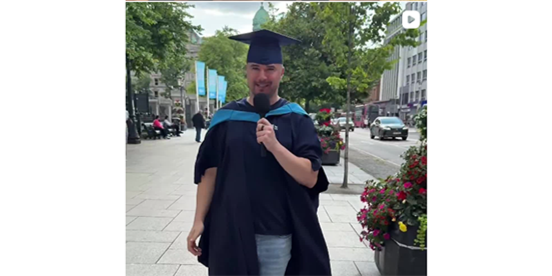 Alan Wallace, Inspiring Belfast walking down the street with a UU gown and cap