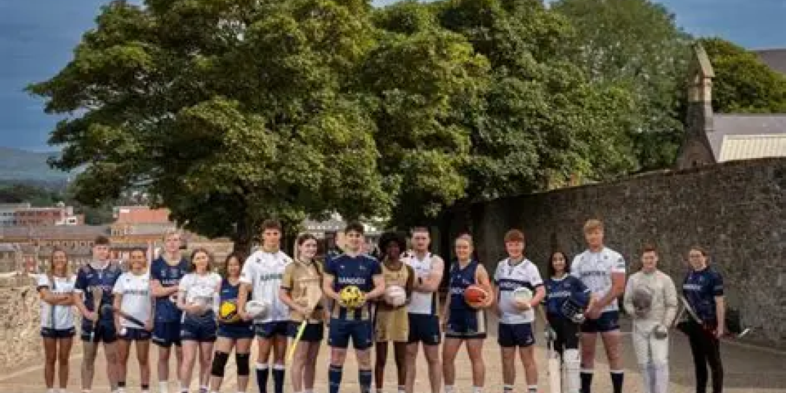 Group of athletes standing outdoors with sports equipment