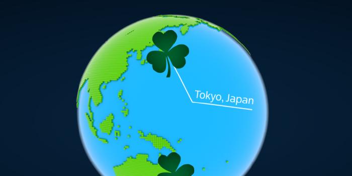 Illustrated globe focused on East Asia and the Pacific Ocean, with a green shamrock marker highlighting Tokyo, Japan.