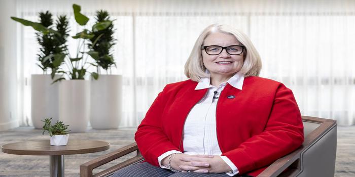 Mairead Lavery, chair of the Canadian Advisory Council sitting in an office setting on a chair