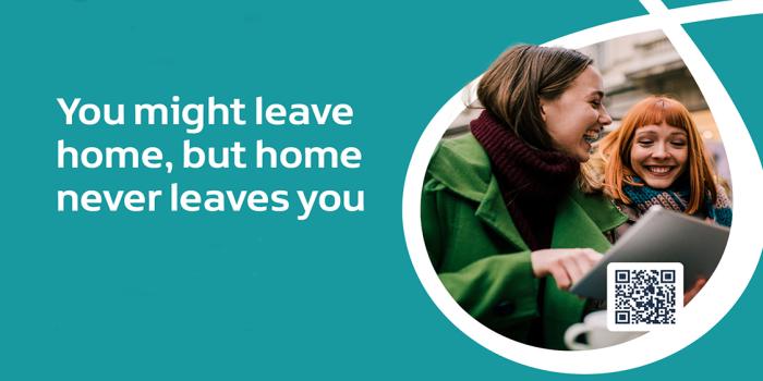 Image of two women laughing and looking at a computer screen with the words You might leave home, but home never leaves you